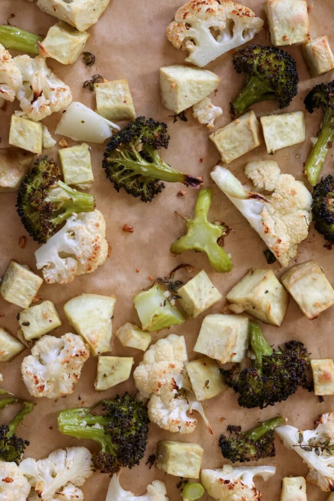 crispy roasted broccoli, japanese sweet potato and cauliflower on a baking sheet