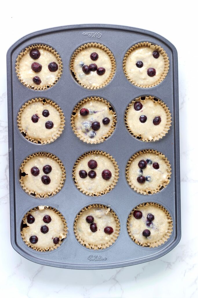 blueberry cottage cheese muffin poured into muffin tins