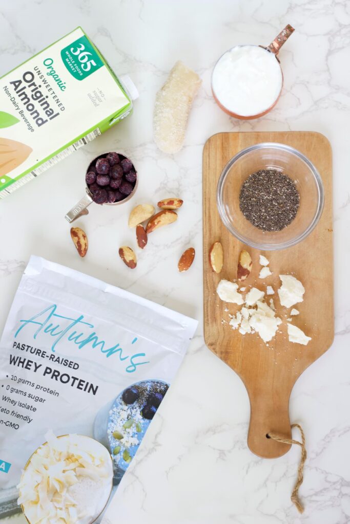 blueberry protein shake ingredients like chia seeds, protein powder, almond milk, brazil nuts, blueberries and coconut butter