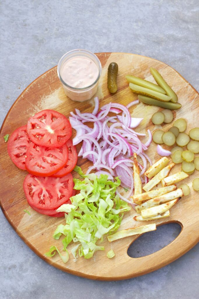 healthy burger bowl ingredients on a cutting board