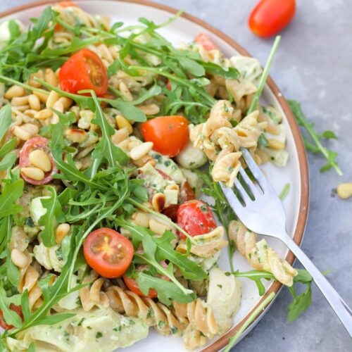 high protein pesto pasta salad with a fork in the plate