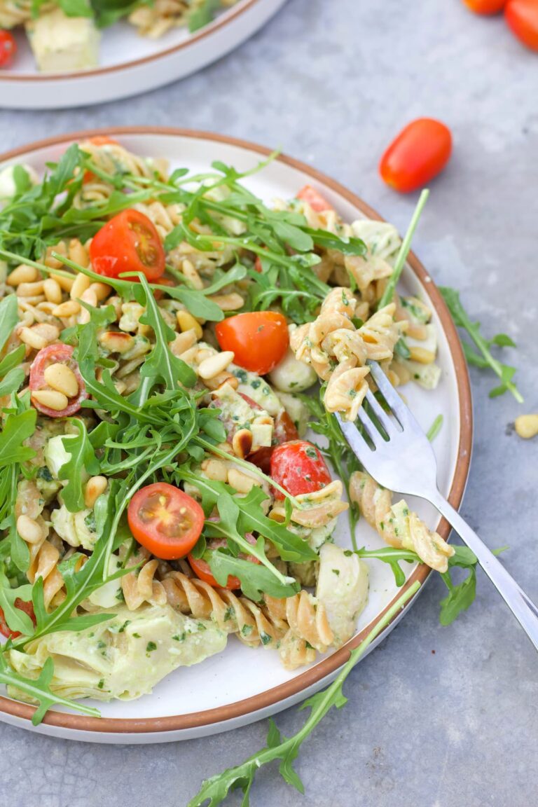 high protein pesto pasta salad with a fork in the plate