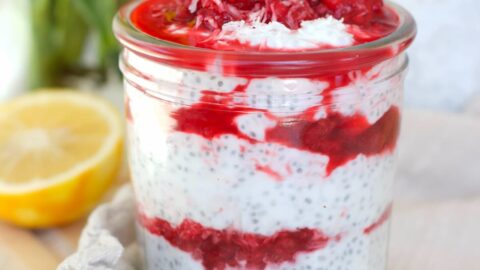 raspberry chia pudding in a mason jar with a lemon