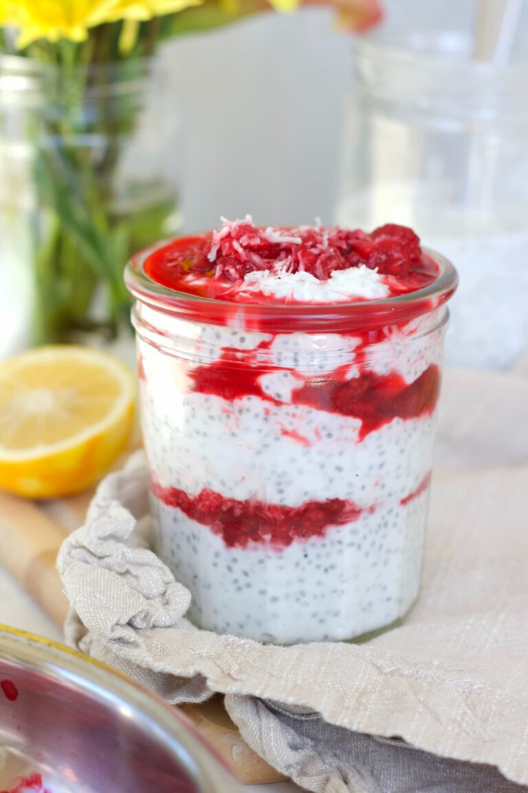 raspberry chia pudding in a mason jar with a lemon