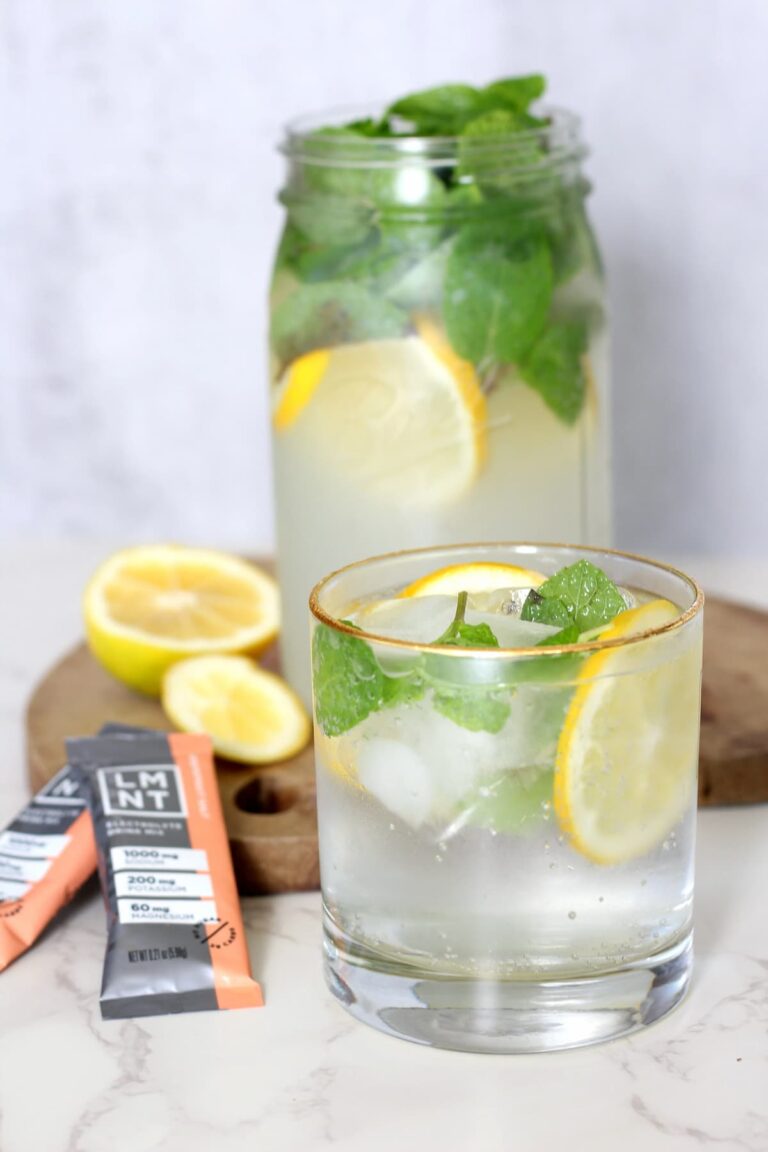 grapefruit mojito mocktail electrolyte drink in a glass with lemons and mint
