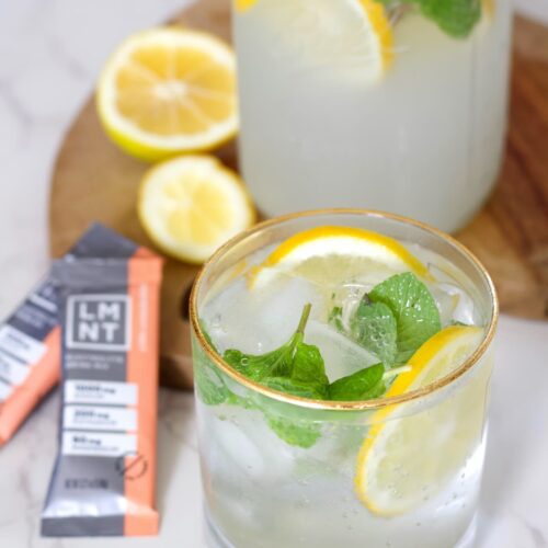 grapefruit mojito mocktail electrolyte drink in a glass with lemons and mint