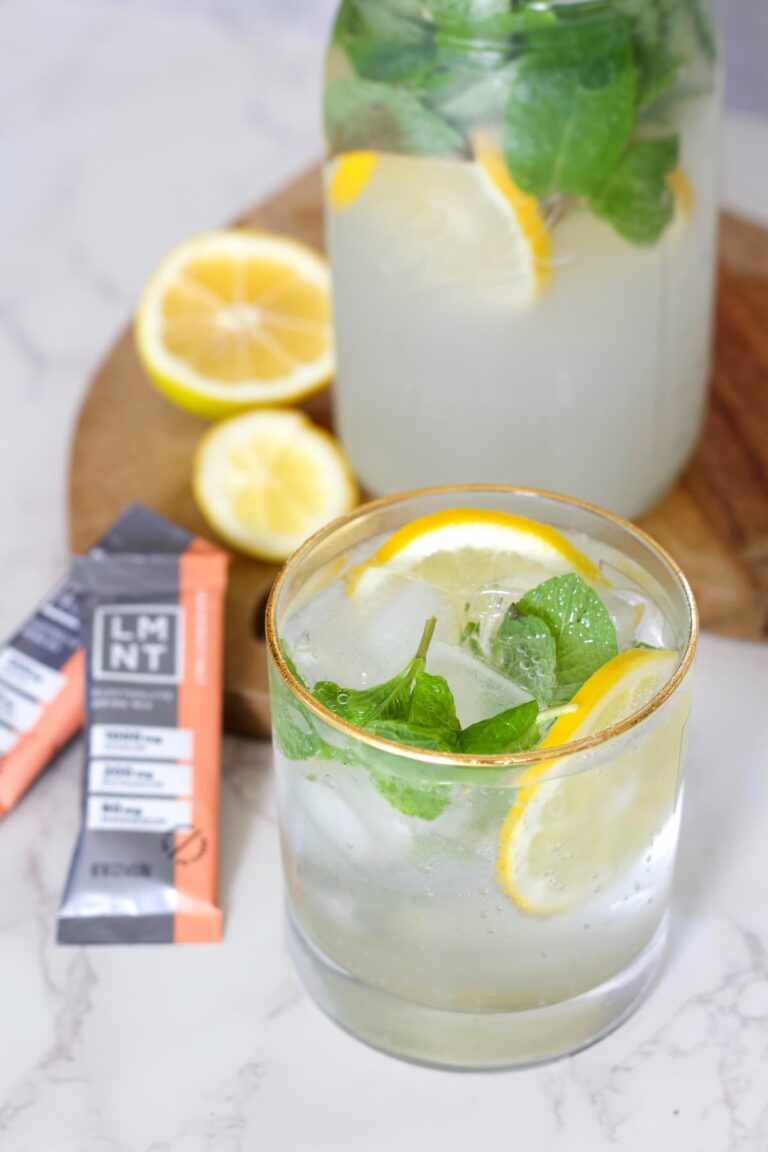 grapefruit mojito mocktail electrolyte drink in a glass with lemons and mint