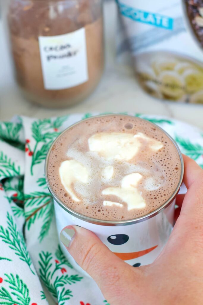 peppermint protein hot chocolate in a mug with whipped cream