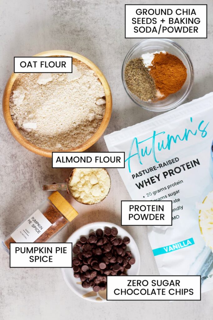dry ingredients for a protein pumpkin loaf including oat flour, almond flour, pumpkin spice, chocolate chips, protein powder and spices