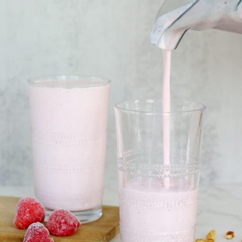 strawberry cottage cheese smoothie being poured into a glass