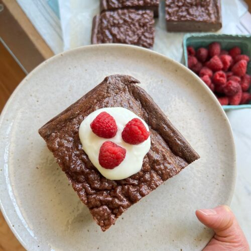 chocolate protein pancakes on a glass with raspberry toppings
