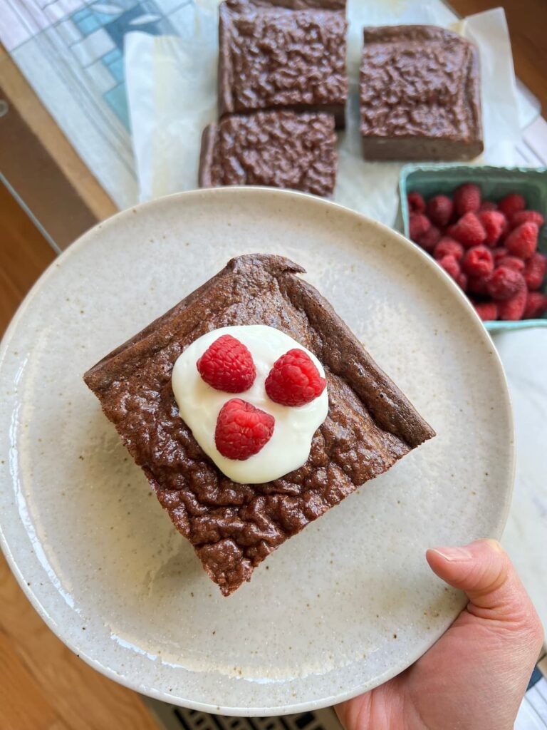 chocolate protein pancakes on a glass with raspberry toppings