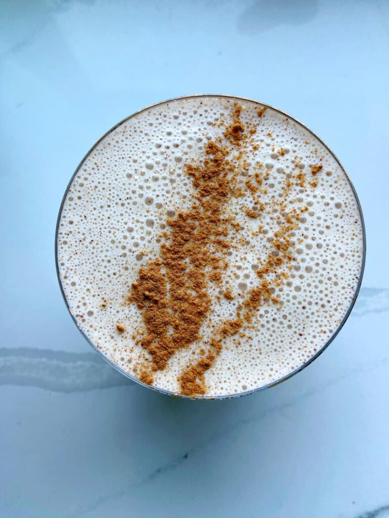 cinnamon roll protein smoothie in a glass