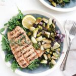 grilled salmon and crispy brussels sprouts on a plate