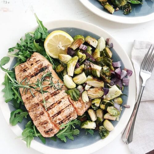 grilled salmon and crispy brussels sprouts on a plate