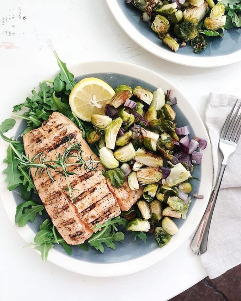 grilled salmon and crispy brussels sprouts on a plate