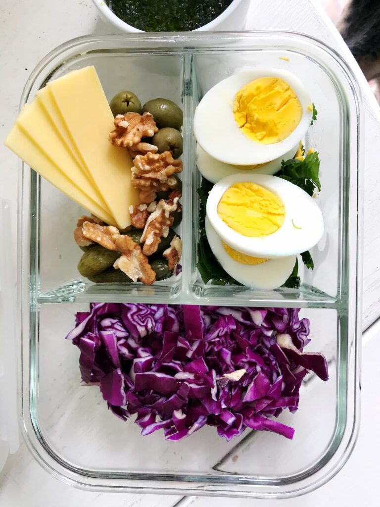 lunch pack with hard boiled eggs, walnuts, olives and cabbage