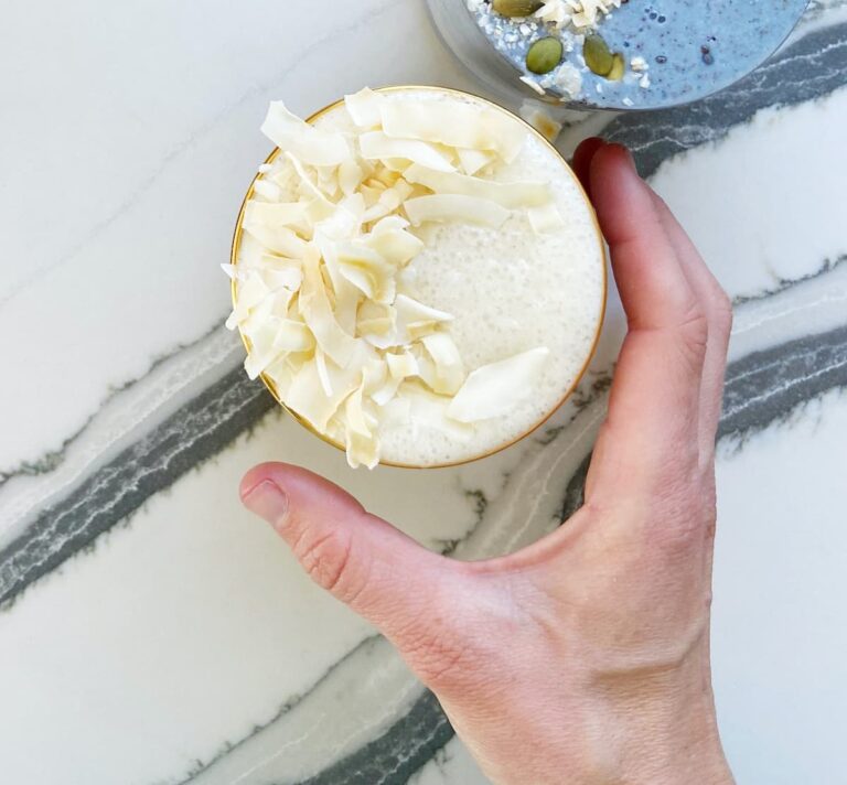 tropical coconut smoothie with coconut flakes on top