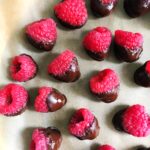 chocolate covered raspberries on a plate