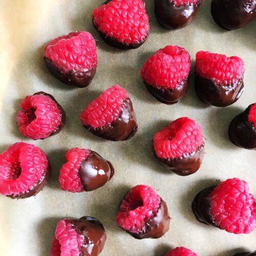 chocolate covered raspberries on a plate