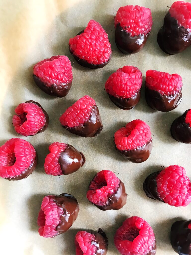 chocolate covered raspberries on a plate
