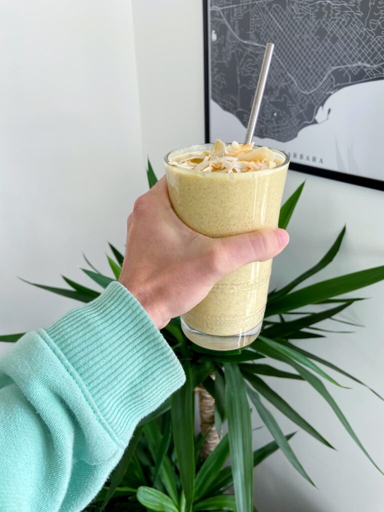 turmeric lemon detox smoothie with coconut flakes on top