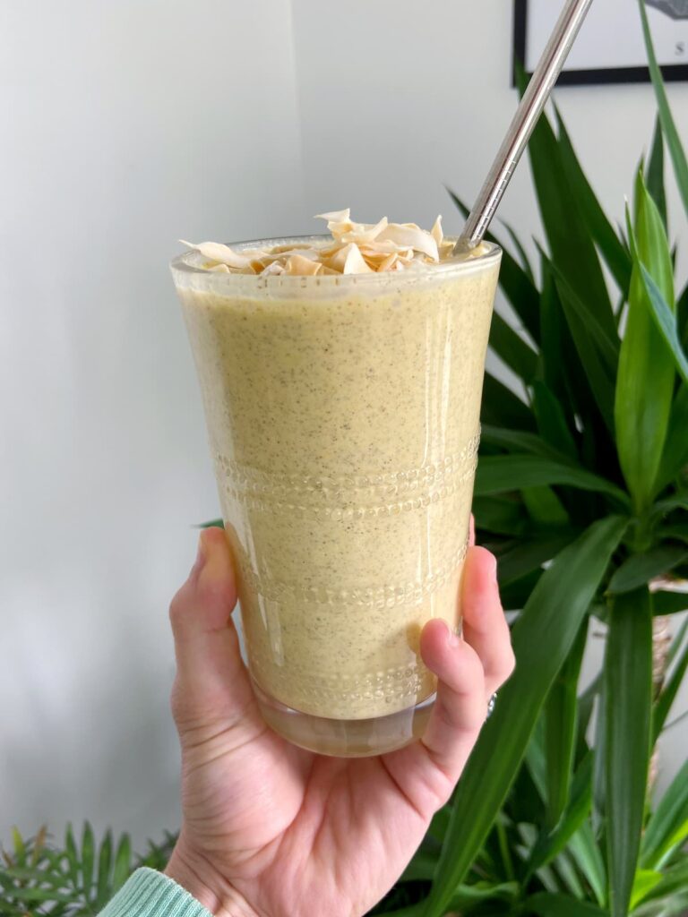 turmeric lemon detox smoothie with coconut flakes on top