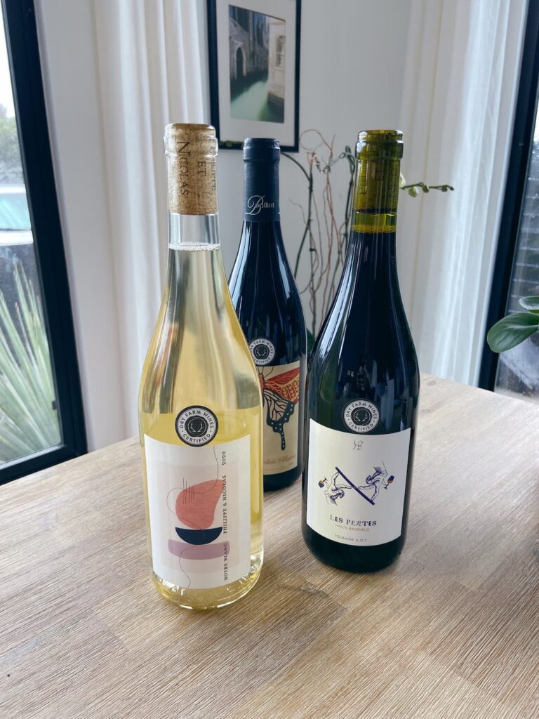 three bottles of dry farm wine on a table