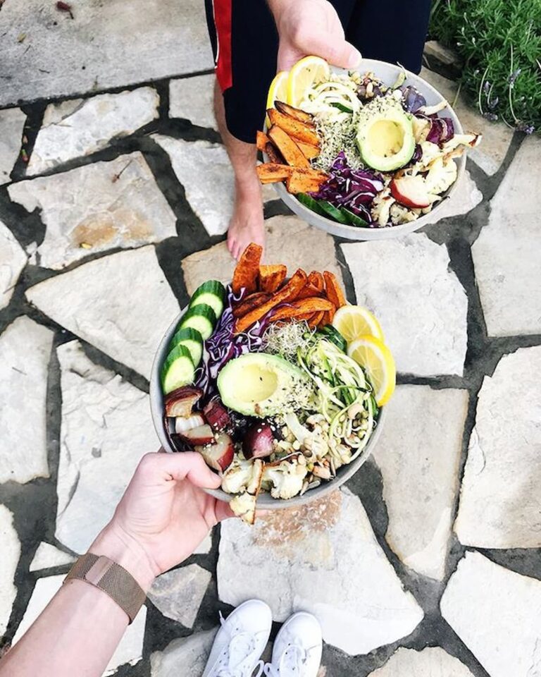two bowls of buddha bowls with avocado and roasted sweet potato fries