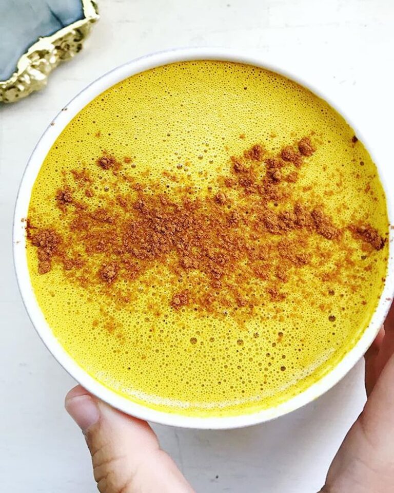 golden milk latte in a mug with cinnamon on top