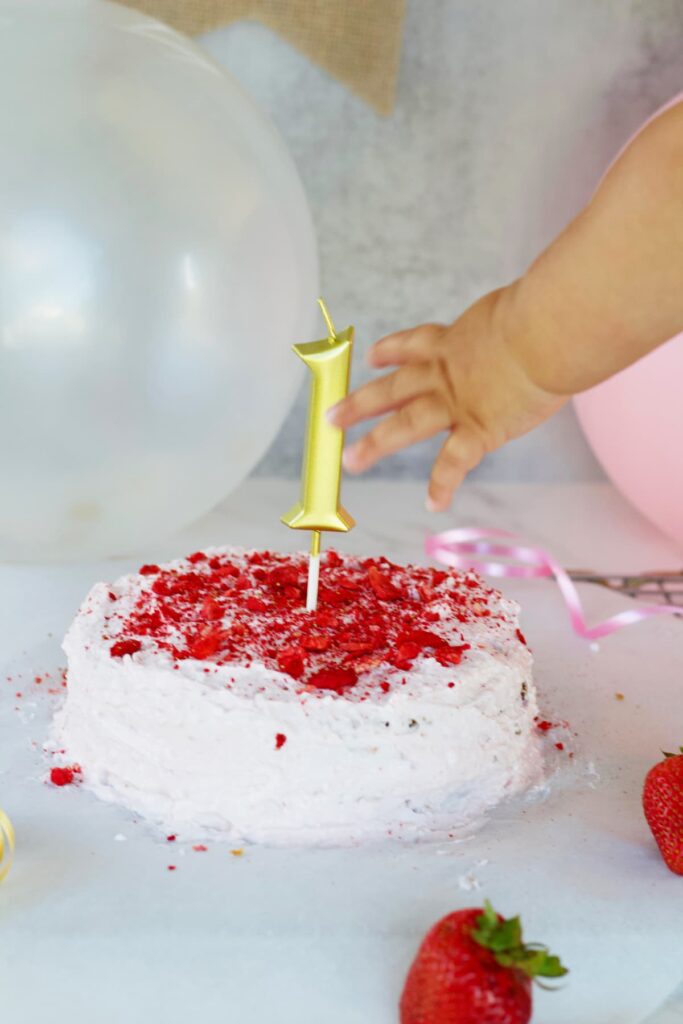healthy smash cake with a baby reaching for it