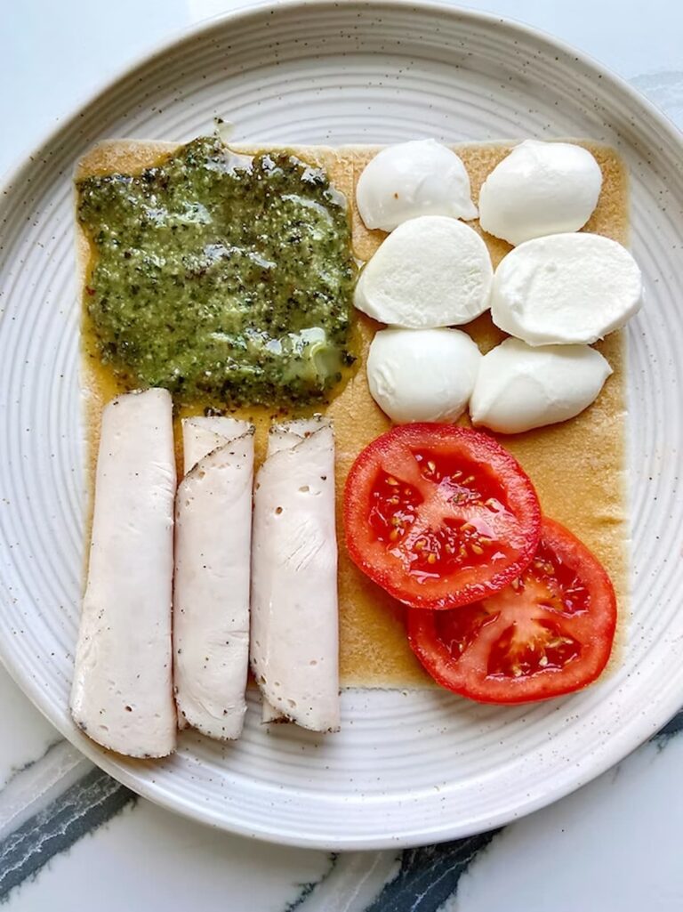 low carb wrap with meat, cheese, tomato and pesto