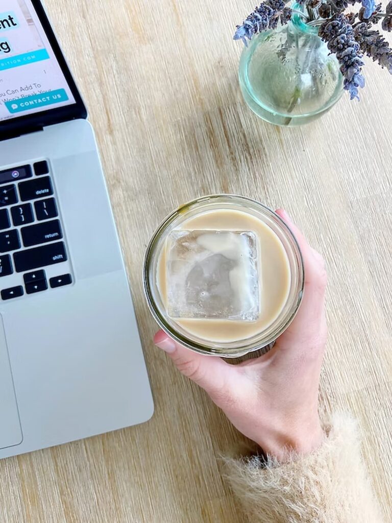 iced coffee next to a computer
