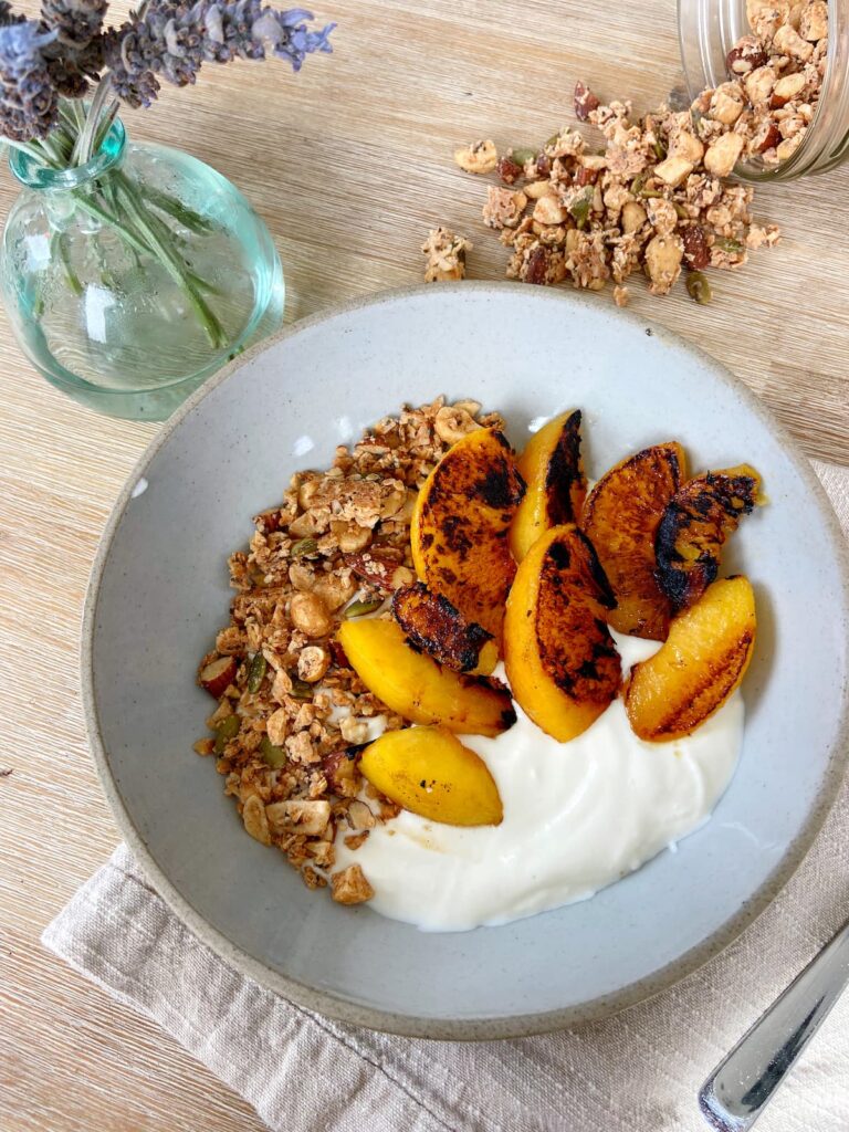 peach and greek yogurt bowl with grain-free granola topping