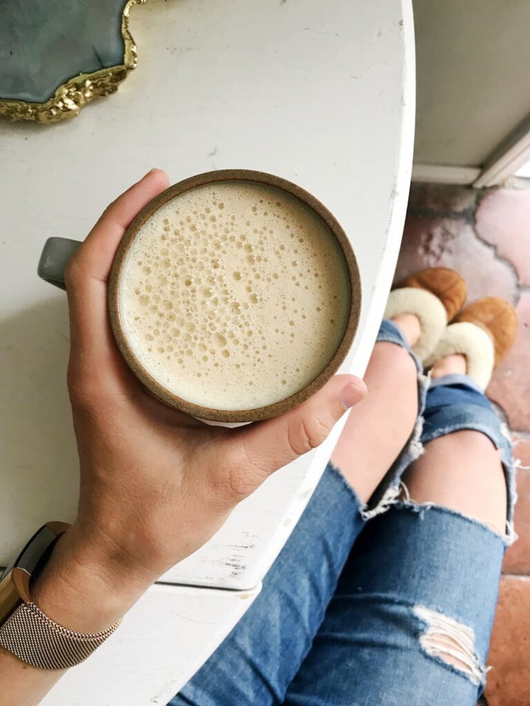 keto coffee being held on a white table