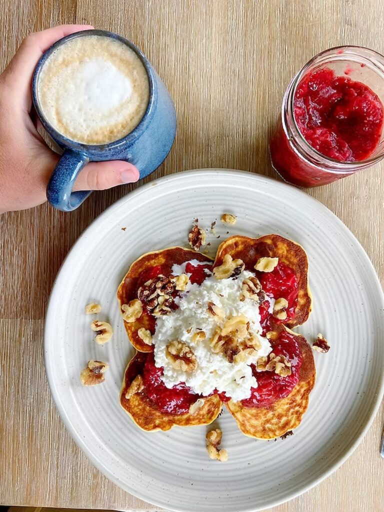 cottage cheese topped on protein pancakes with a latte