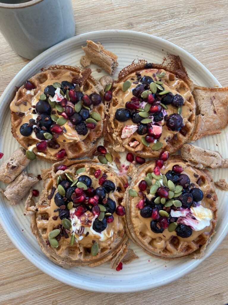 four protein waffles with blueberries, greek yogurt and seeds topping