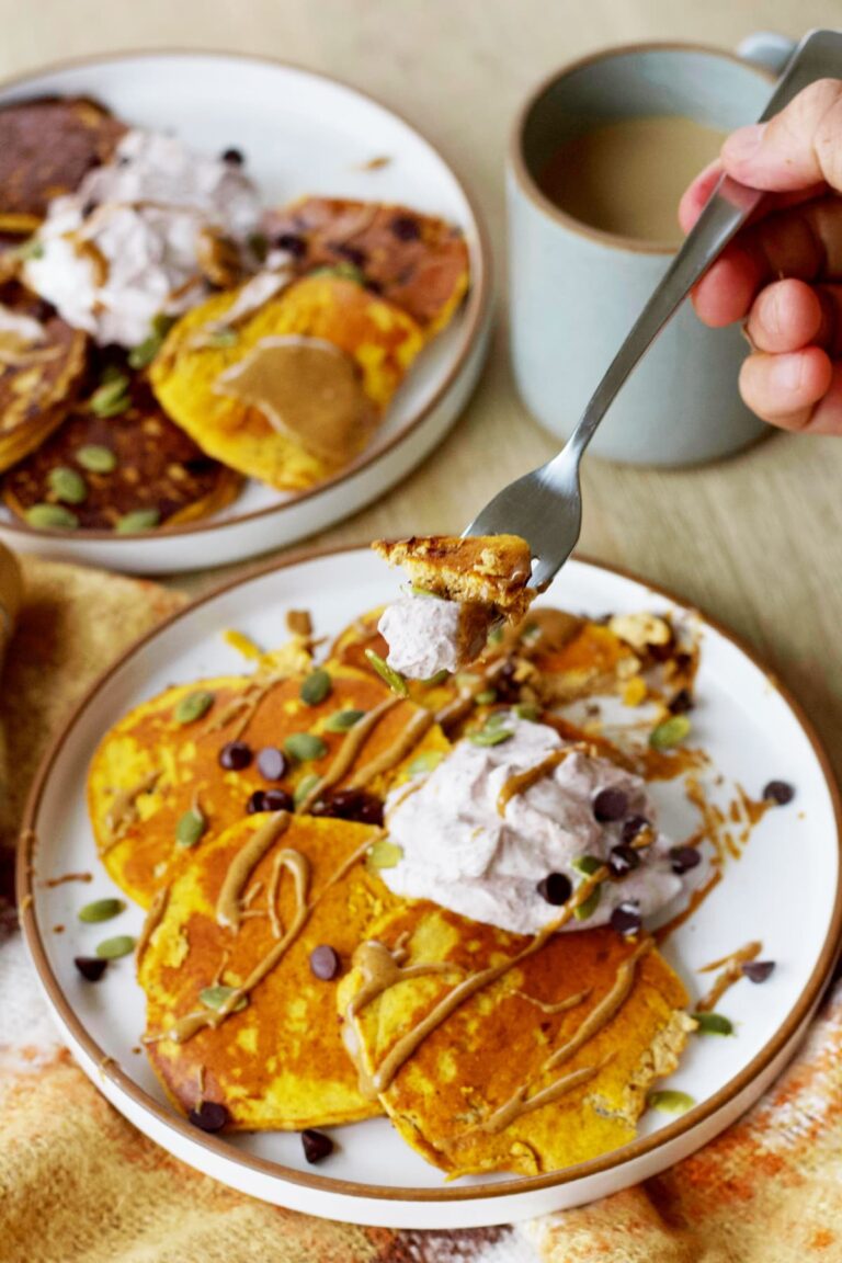 pumpkin protein pancakes close up on a fork with toppings