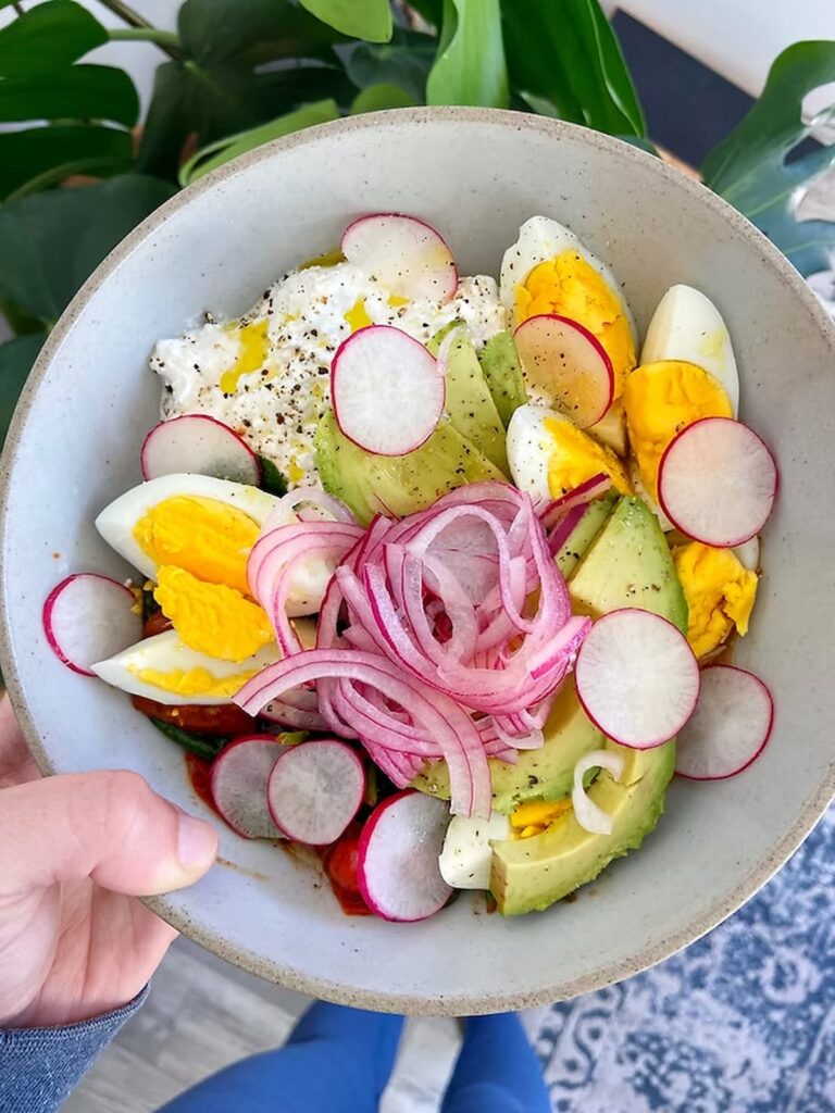 savory cottage cheese bowl with eggs, avocado and onions