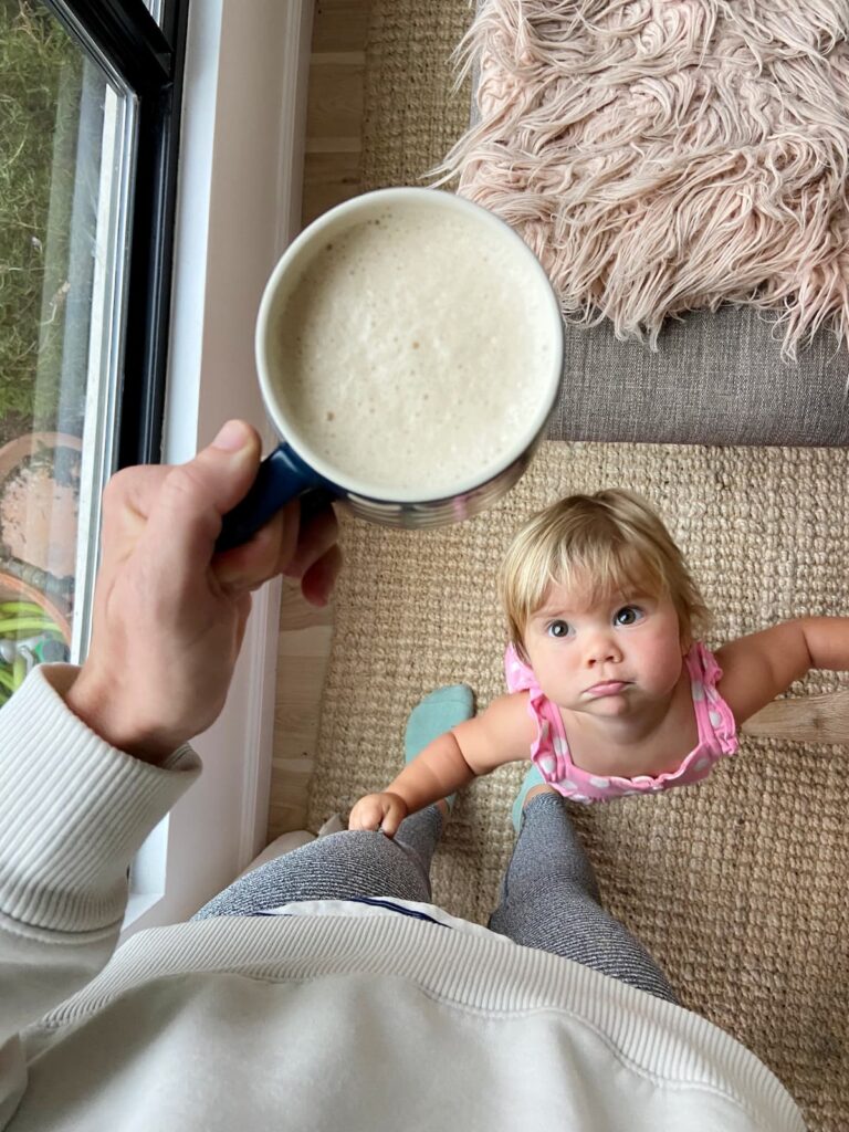 vanilla protein coffee with a toddler looking up at it