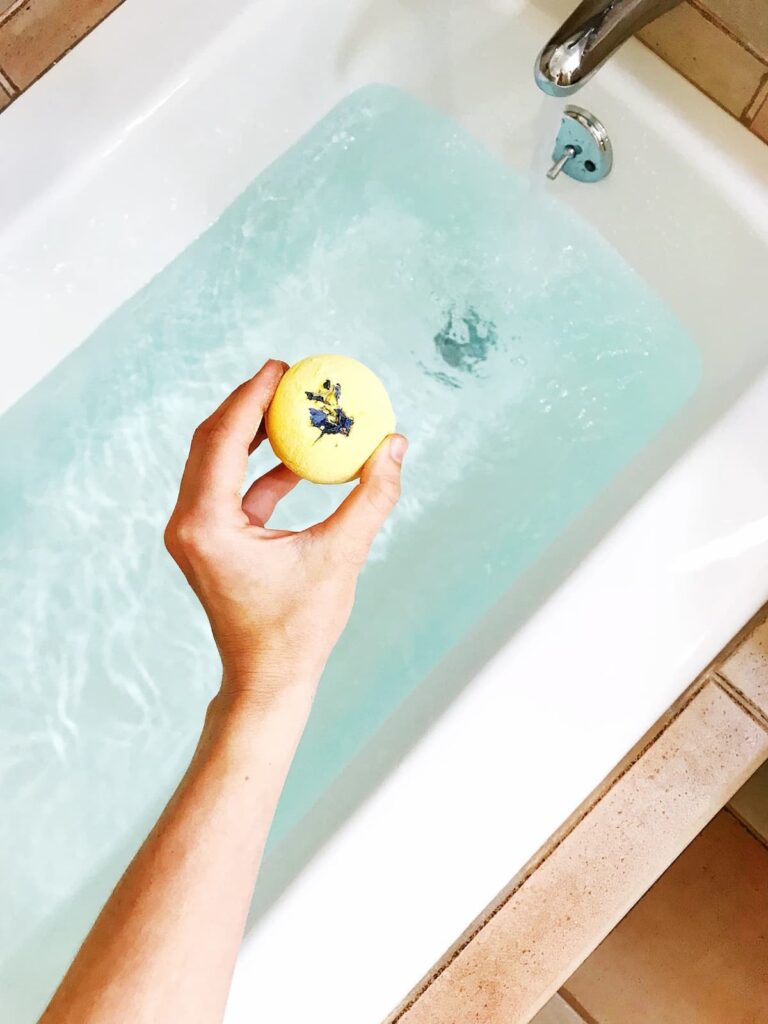 yellow bath bomb in a bath
