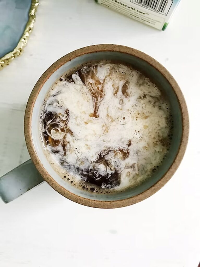 a cup of black coffee with heavy cream
