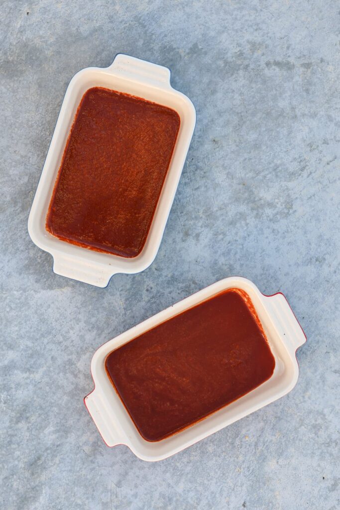 enchilada sauce in two individual ceramic dishes