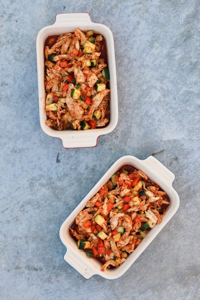 healthy chicken enchiladas in individual ceramic baking dishes without the topping