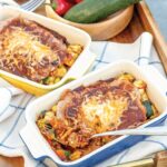 healthy chicken enchiladas in individual ceramic baking dishes