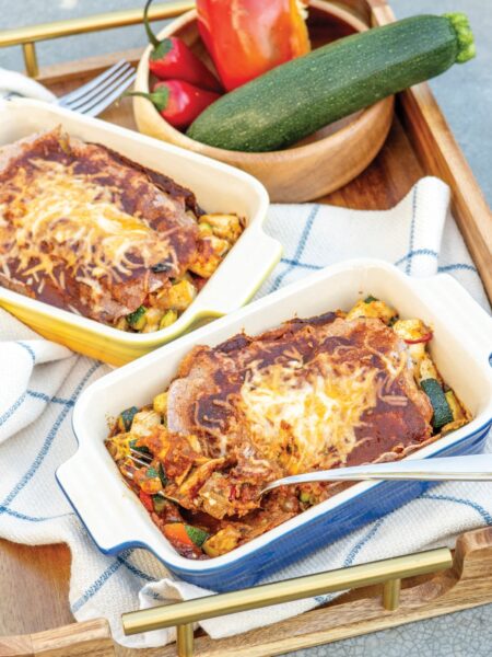 healthy chicken enchiladas in individual ceramic baking dishes