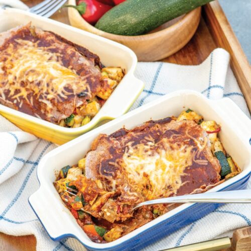 healthy chicken enchiladas in individual ceramic baking dishes