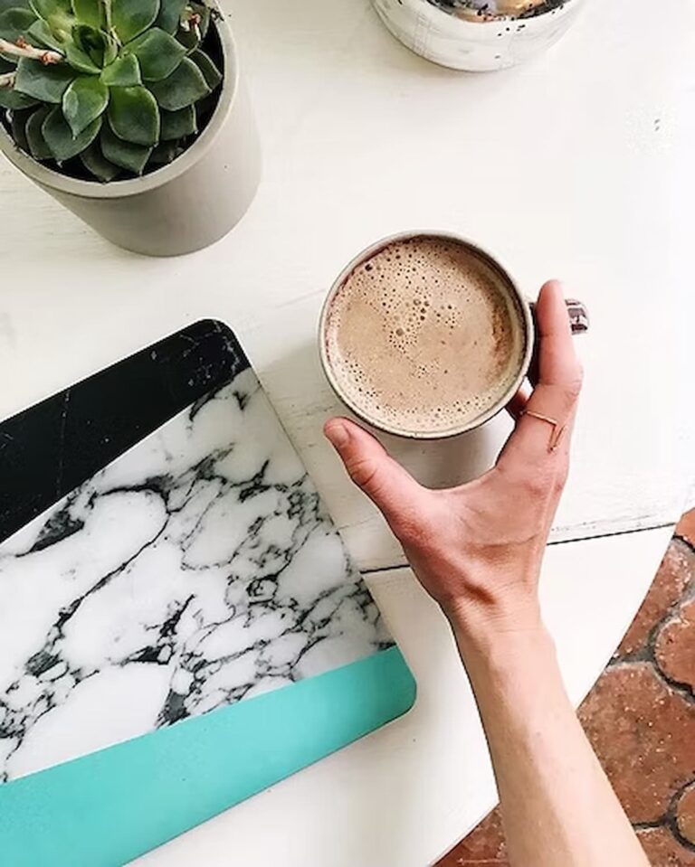 keto coffee in a cup next to a computer
