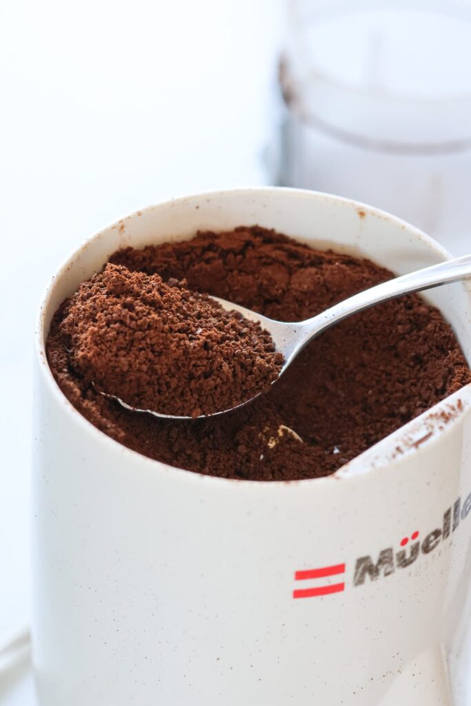 freshly ground coffee beans in a grinder
