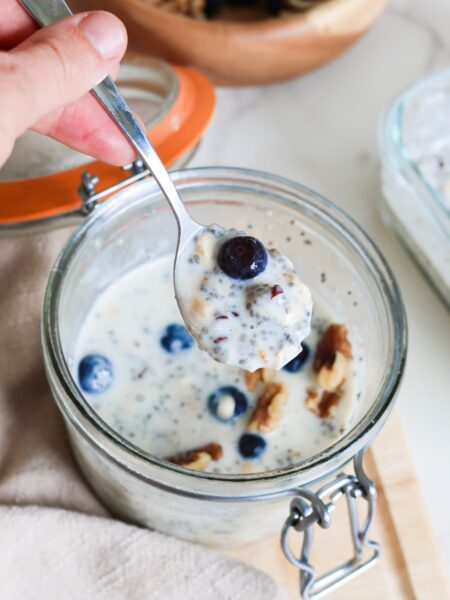 close up of high protein overnight oats with blueberries and walnuts